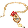 Collier Dolce &amp; Gabbana en laiton doré avec pendentif en cristal rose Sacré-Cœur