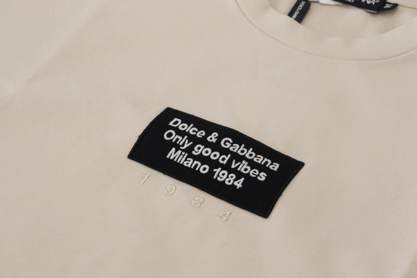 Dolce &amp; Gabbana Elfenbeinfarbener Baumwoll-Pullover mit Print und Rundhalsausschnitt